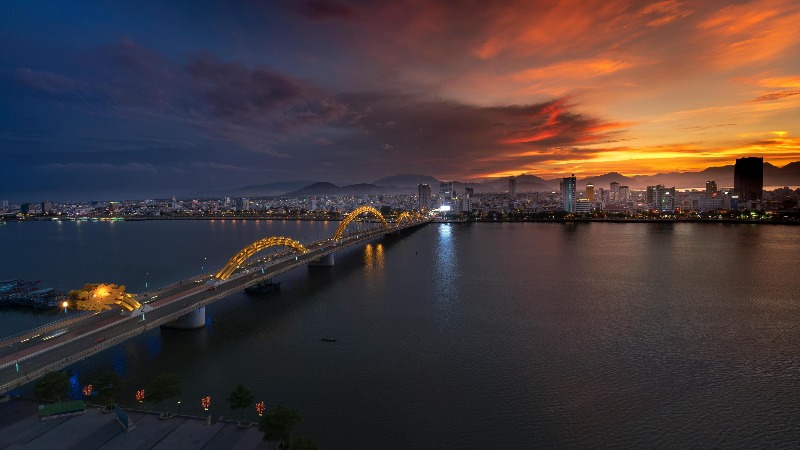 Da Nang Vietnam Dragon Bridge at sunset with city skyline and Han River view
